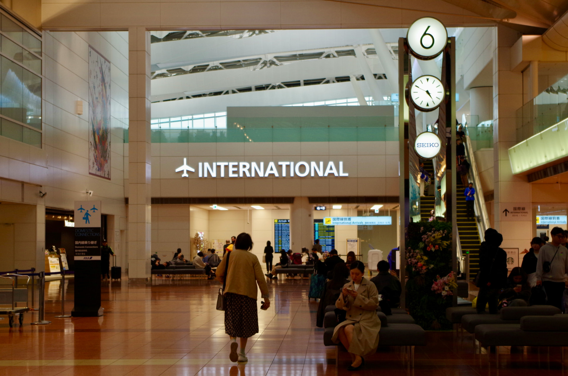Travelers moving through an international airport terminal